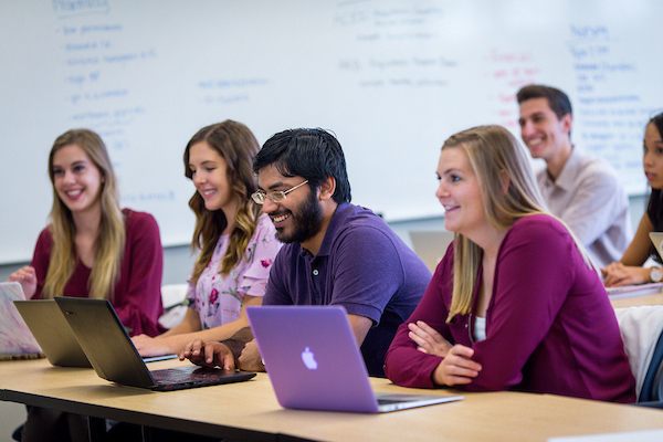Pharmacy students participating during a class lecture.